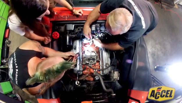 ACCEL's Jenny Long, vehicle caretaker Steve Hanzi, and mechanic Timmy Hinkle of Little Green Customs install an ACCEL recipe for performance '68 Corvette