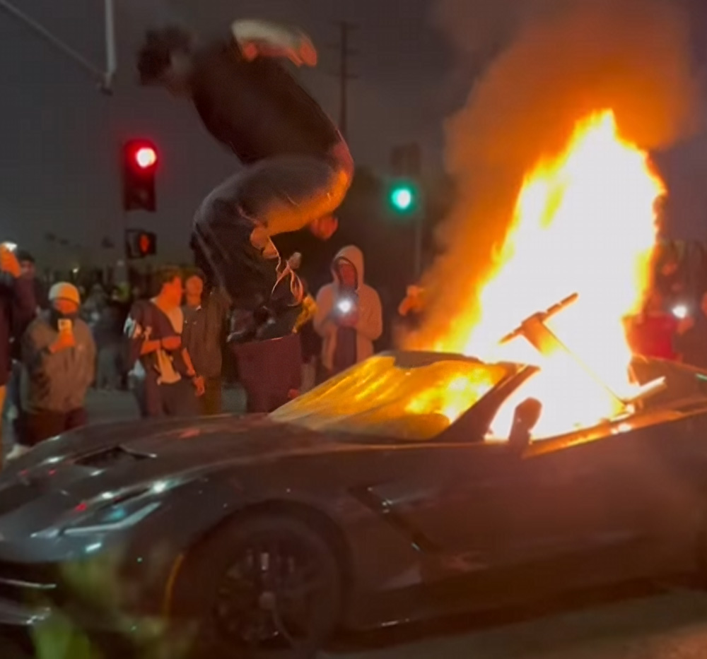 C7 Corvette on fire in Los Angeles during takeover with person jumping on the hood